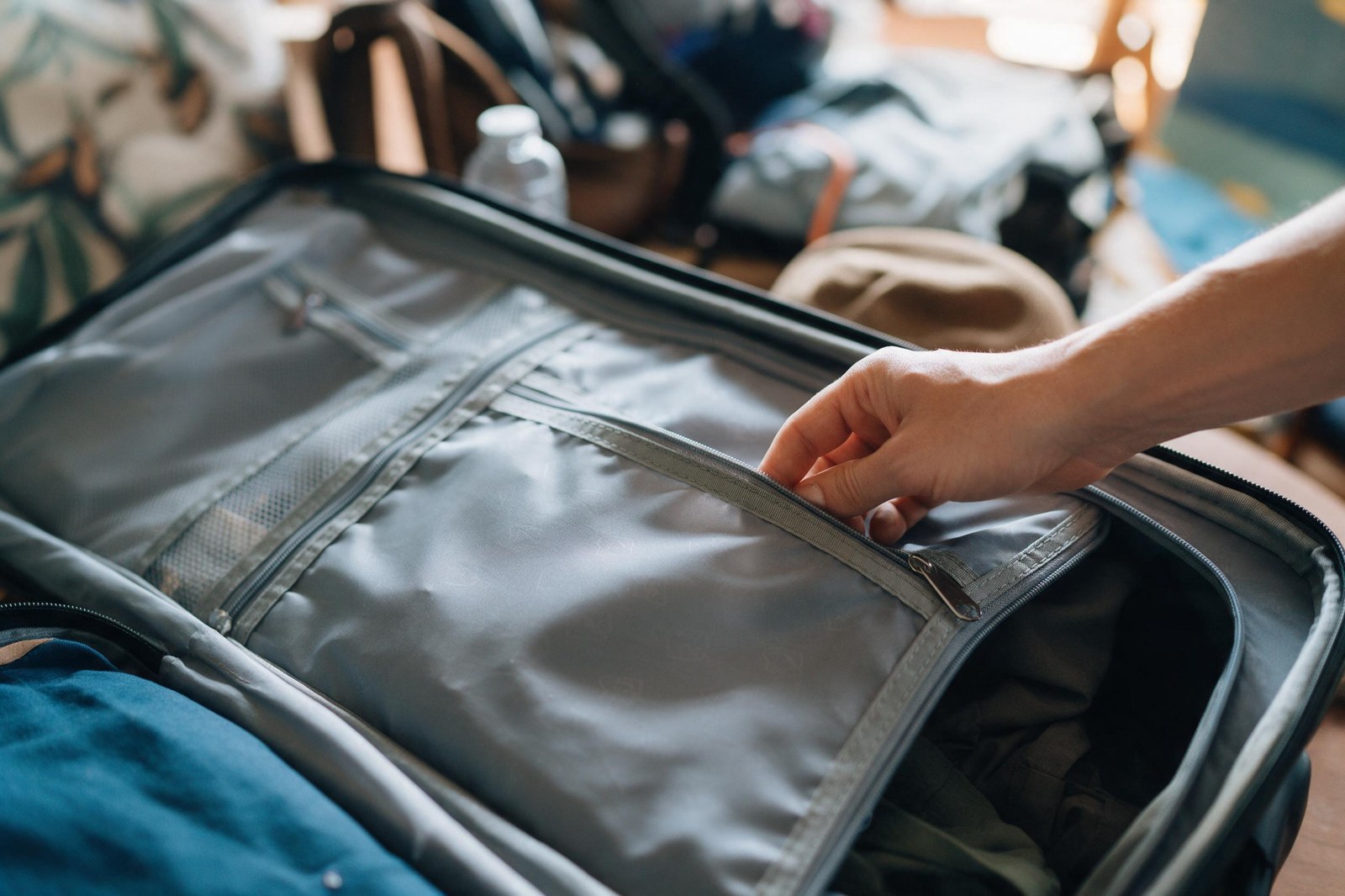 close-up of an open suitcase interior pocket being checked
